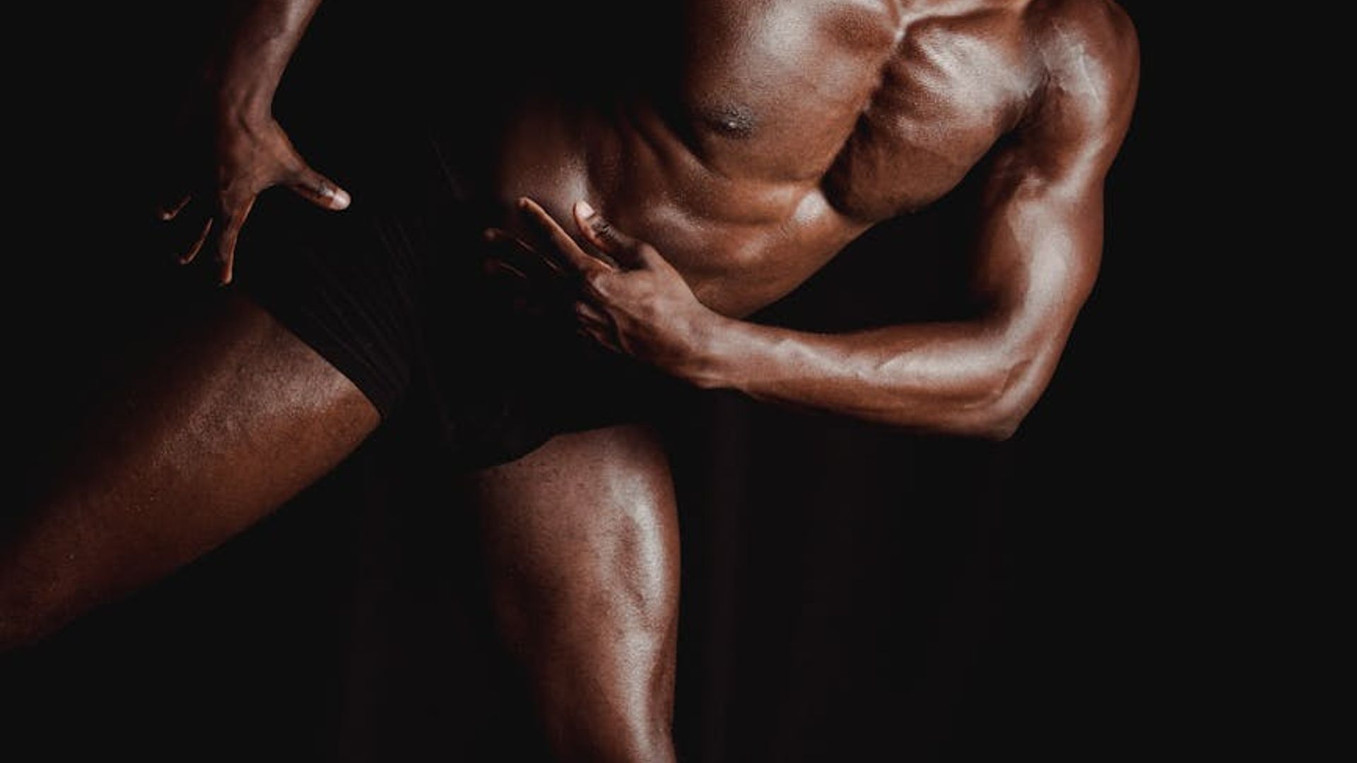 Person doing dynamic exercises in a modern dark studio